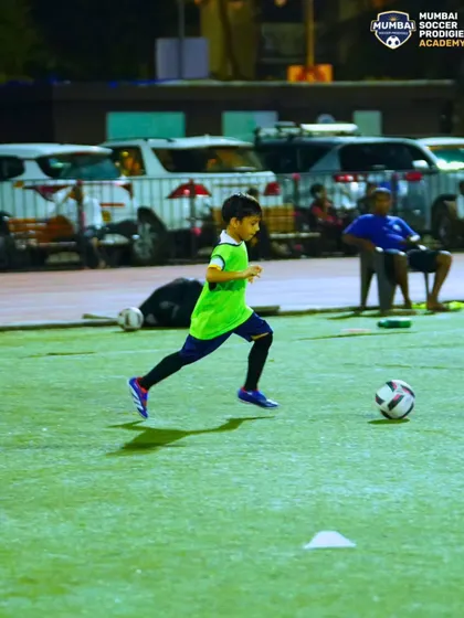 A player sprints with the ball during a dribbling drill, showcasing speed and close control.