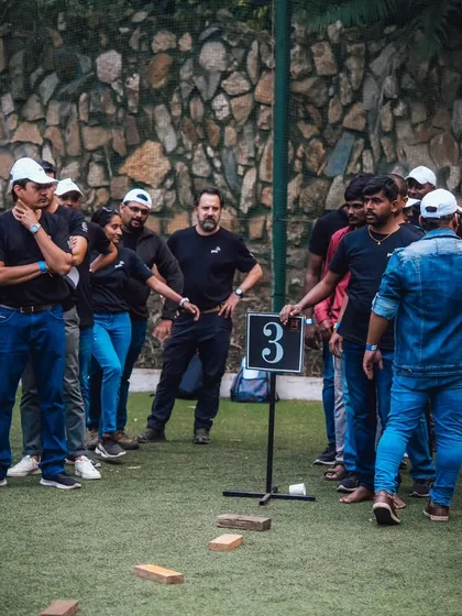 A team listens intently to instructions for a brick-walking challenge, another one of my unique team building exercises.