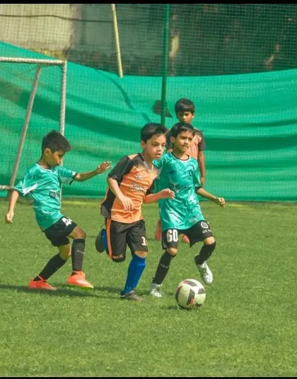 Our U9 players swarm the ball, demonstrating energetic and collective defending.