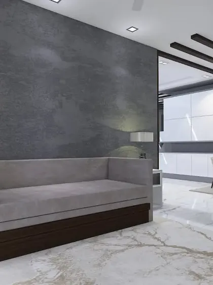 A cozy seating nook with a daybed, separated from the main living area by folding glass doors.