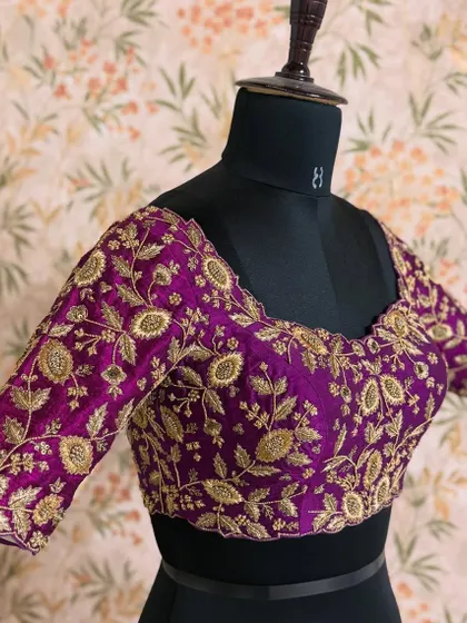 The full view of the purple blouse, showing how the heavy embroidery covers the sleeves and neckline, making it a perfect statement piece.