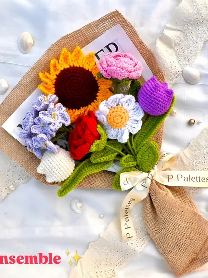 The "Ensemble" bouquet, a beautiful mix of our most popular crochet flowers including a sunflower, rose, and tulip, wrapped in rustic jute.