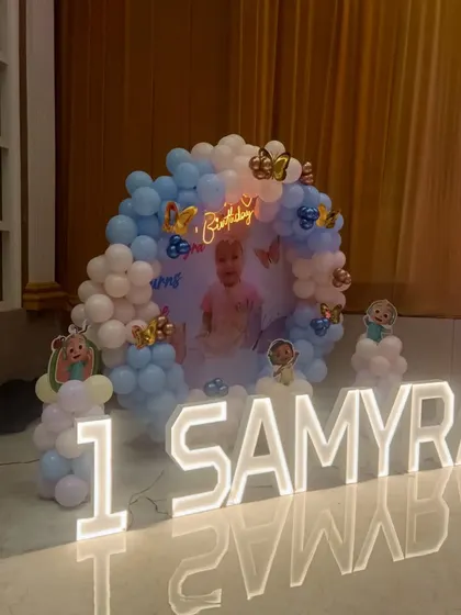 A soft and sweet Cocomelon theme for Samyra's first birthday. The pastel blue and white balloons, combined with a personalized backdrop and light-up letters, create a dreamy atmosphere.