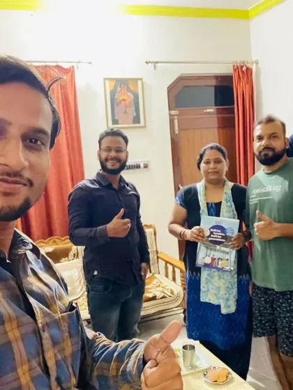Our team with a family, all smiles and thumbs-up for their new solar investment.