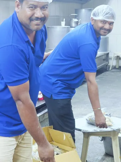 A behind-the-scenes look at our team working in the kitchen, preparing food with smiles on their faces.