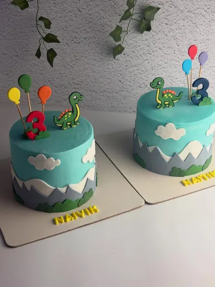 The pair of "twin-sauruses" cakes, ready for a roar-some celebration.