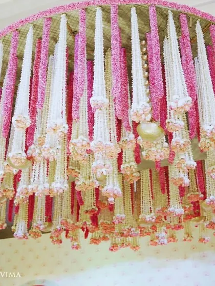 An enchanting chandelier made entirely of fragrant jasmine (mogra) and delicate pink lotuses. This was a stunning centerpiece for a traditional half-saree function, filling the air with a beautiful scent.