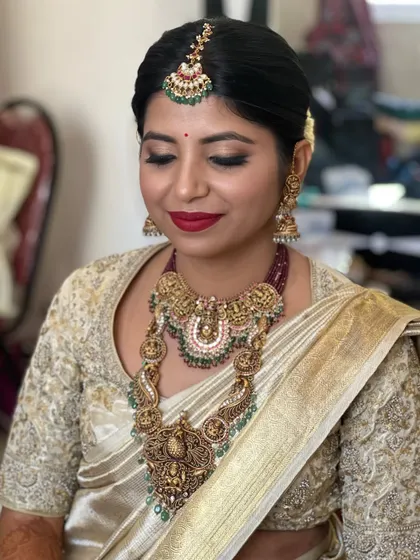 This bride's look is a beautiful balance of glamour and tradition. The smokey eye is paired with a bold red lip, a combination that you will learn to execute flawlessly for your clients.