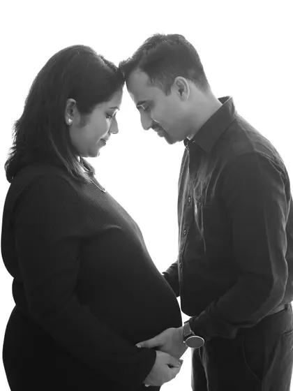 An intimate black and white portrait of a couple, forehead to forehead. Removing color allows the focus to be entirely on the emotion and connection.