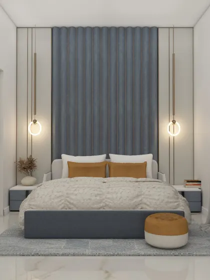 This bedroom features a striking blue upholstered headboard with vertical fluting, creating a bold focal point. The circular pendant lights add a modern touch to this comfortable and stylish space.