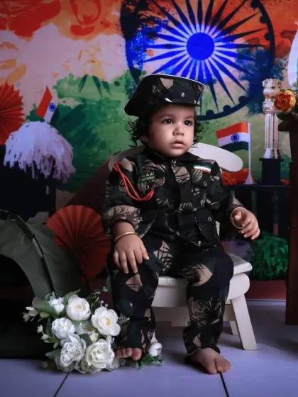 A profile shot of our little soldier. The detailed costume and patriotic backdrop make for a very special and memorable photograph.