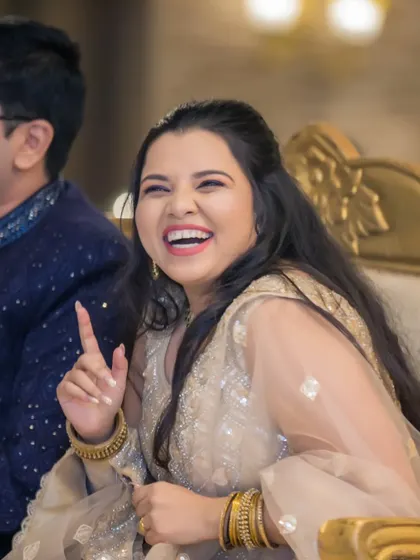 The bride's infectious laughter during the Sangeet, a candid moment that radiates pure happiness.