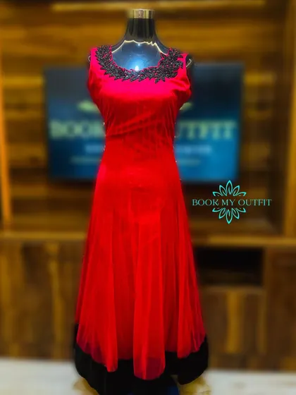 This elegant red gown features a soft net overlay and a bodice adorned with black leaf-patterned beadwork. Its classic A-line shape is universally flattering and perfect for a variety of formal events.
