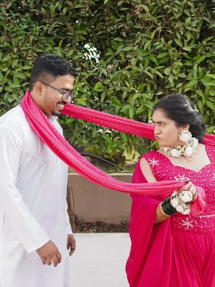A playful tug-of-war with the groom's scarf, a fun and candid moment from a Haldi celebration.