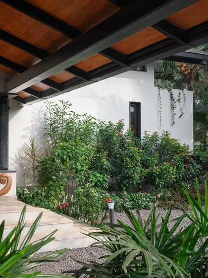 A duplicate of image 45, showing the lush entrance landscaping at Grove House.