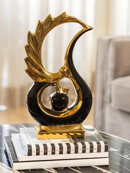Symbolizing strength and renewal, the Phoenix Rise figurine is an exquisite representation of the mythical bird. The abstract design in black and gold makes it a striking and symbolic showpiece.