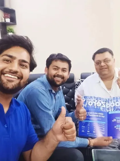 Our team takes a selfie with a customer holding our "GoodZero" brochure.