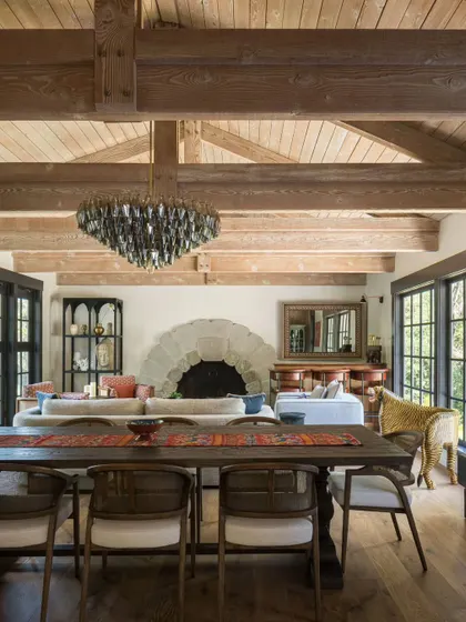 The open-concept living and dining room in Saratoga, showcasing the home's grand scale and rustic-chic aesthetic. The design allows for easy flow between the different zones, making it perfect for both family living and entertaining.