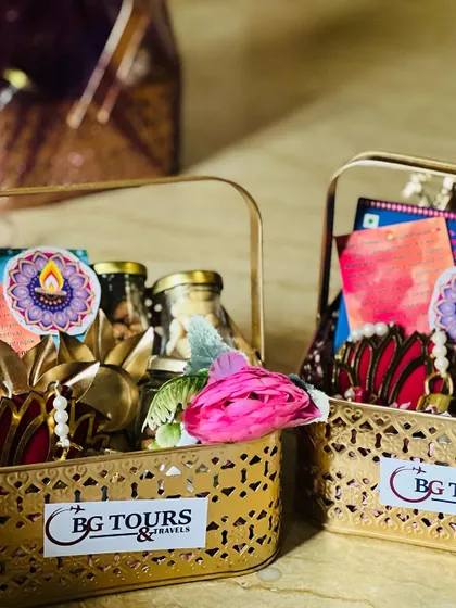 A pair of branded Diwali gift baskets for a corporate client, showcasing the logo sticker and festive contents.