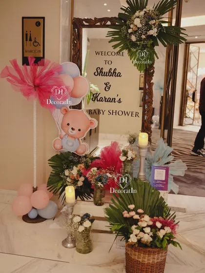The welcome entrance for Shubha and Karan's baby shower, featuring a mirror sign and floral arrangements.