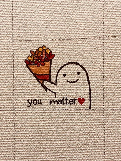 Day 22: A little ghost holding flowers with a reminder: "you matter."