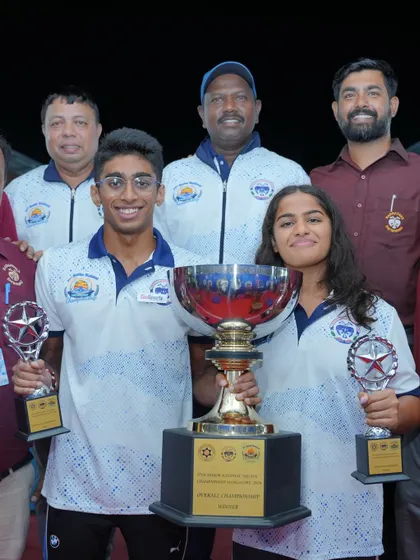 Our champion swimmers Aneesh and Hashika with the main trophies.