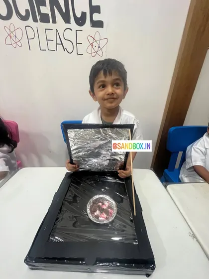 This student shows off his handmade solar cooker, ready for testing. These projects demonstrate that science can be used to create useful, eco-friendly technology.