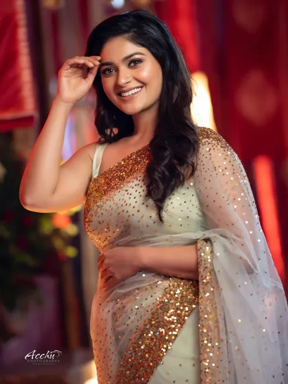 A candid and happy moment from the same event. The soft lighting and genuine smile make this a beautiful, natural portrait that captures the festive atmosphere.