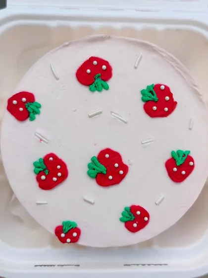 A cute strawberry-themed bento cake. The little fondant strawberries and sprinkles make for a simple and cheerful design.