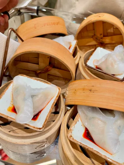 Steamed dumplings served in individual bamboo steamers, a highlight from the Tasva fashion launch event.