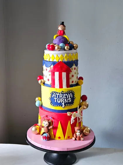 Welcome to the carnival! This was my first four-tiered carnival theme cake, complete with a carousel horse, a ringmaster, and vibrant circus tent colors. It's a towering piece of edible art for a grand first birthday.