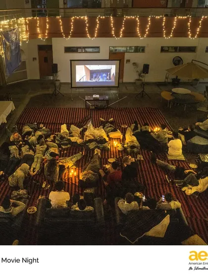 An overhead view of the magical setup for Senior Movie Night, complete with fairy lights and a big screen. We go the extra mile to make these milestone events feel special for our students.