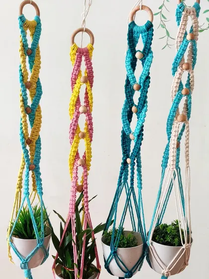 A set of four colorful plant hangers, each with a unique two-tone design. These are perfect for creating a vibrant, hanging garden indoors.