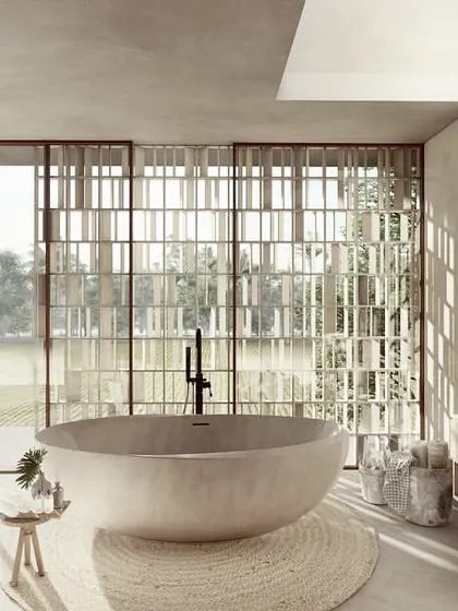 This bathroom in a Pavilion home overlooks the vast paddy fields through a wall of perforated screens. The freestanding tub is positioned to take full advantage of the view, creating a bathing experience that is fully immersed in the landscape.