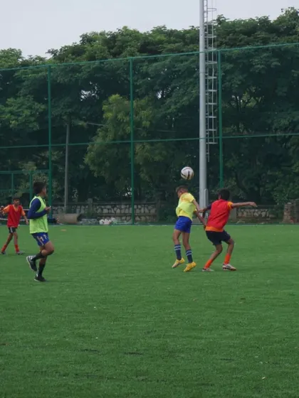 Players compete for a header in midfield. Controlling the middle of the park is crucial, and we look for players who can dominate this area.