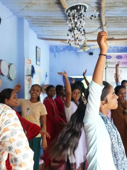 A moment of energy and expression in the workshop. We used not just drawing but also movement to explore our stories. Here, the girls are standing with their arms raised, participating in an activity with joy and confidence.