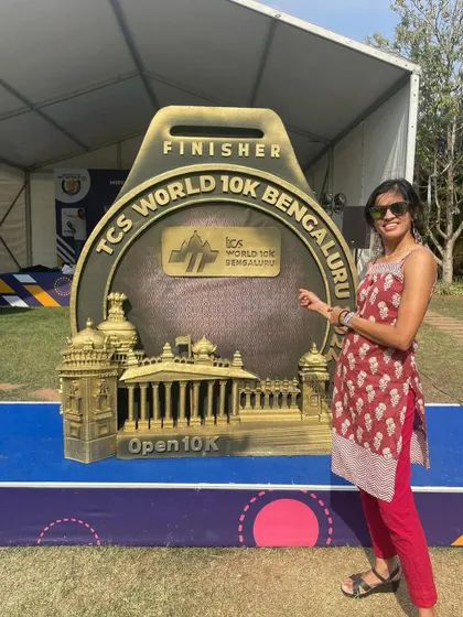 Posing with the giant finisher medal at the TCSW10k expo. A little motivation for the run ahead.
