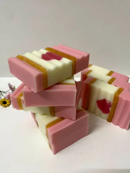 This image showcases a collection of the pink and white heart soaps, ready to be packed for a custom order.