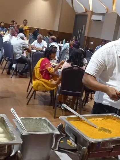 Guests enjoying a community dinner at Brigade Cornerstone Utopia, featuring our extensive buffet with favorites like Rasgulla.