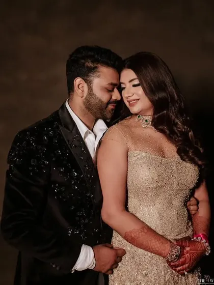 An intimate portrait of the couple on their cocktail night, his classic black-tie look complementing her sparkling gown.