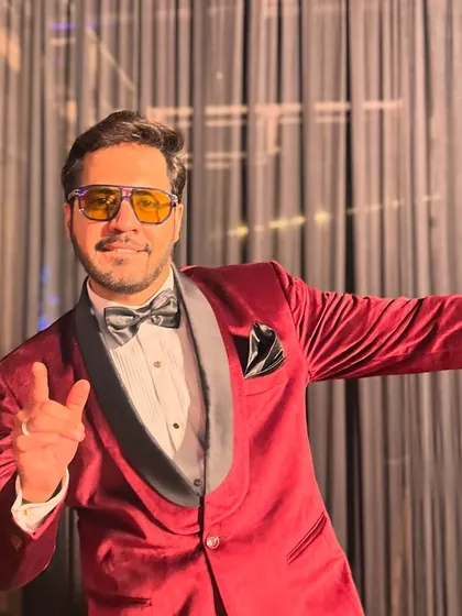 A fun and confident pose, showing off the vibrant color and sharp cut of the tuxedo.