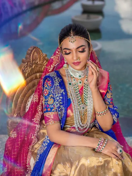 A fusion look combining a traditional half-saree with modern layered jewelry. This set features a diamond-simulant choker and a long haram with green beads, showing how my pieces can be styled for unique, contemporary events.