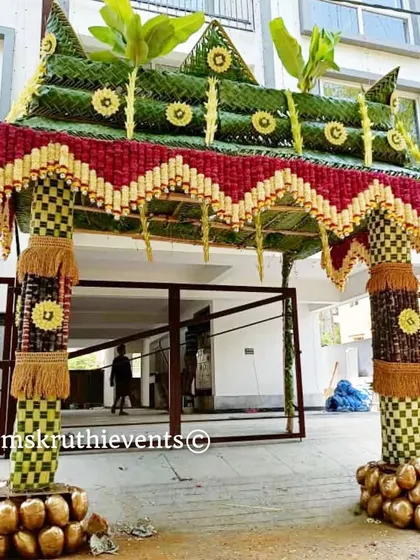 Another angle of our grand Chappra, showcasing the detailed craftsmanship. The pillars are wrapped in checkered leaf patterns and the base is decorated with coconuts, symbolizing prosperity.