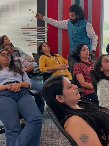 Even in office chairs, deep relaxation is possible. I am using chimes to create high-frequency sounds that help to elevate the energy in the room during a corporate wellness session for 7-Eleven.