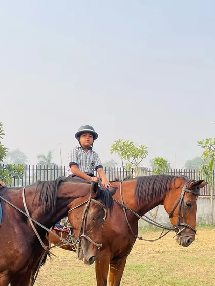 Students of different ages riding together with an instructor. Our lessons cater to a wide range of age groups and skill levels.