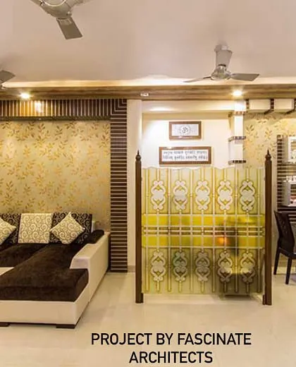 This living room in Kharghar uses a combination of textured wallpaper and wood fluting to create a warm and inviting space. A glass partition provides a subtle division from the dining area while maintaining an open feel.