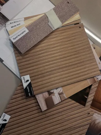 A glimpse into the customization process. Here you can see various veneer samples, including fluted and dyed options, ready to be selected for a bespoke project.