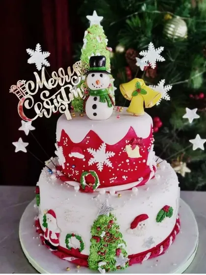 A closer look at the details on our two-tier Christmas cake. Every element is carefully crafted to bring the holiday spirit to your dessert table.