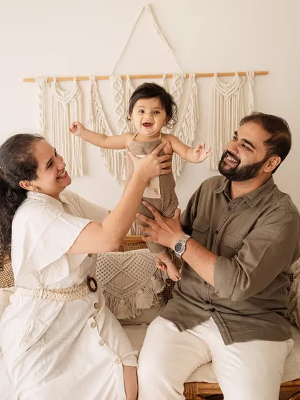 A moment of pure family fun. This photo captures the dynamic and playful energy of a family enjoying their session together.