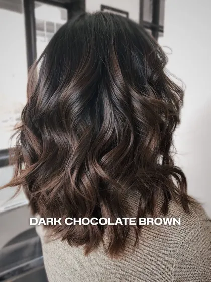 This dark chocolate brown is a classic for a reason. We added subtle dimension with lighter tones and styled it with soft waves for a rich, luxurious finish.